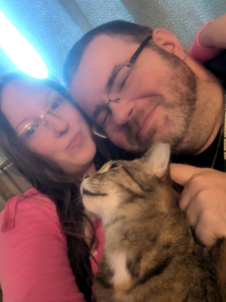 The husband-and-wife team behind Dream Engine Studios with their cat